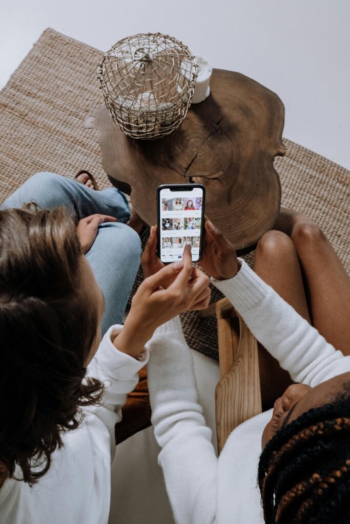 Modern workspace setup with a DSLR camera, laptop editing fashion photos, and digital drawing pad on a wooden desk inside a creative studio—ideal environment for SOCIAL MEDIA MARKETING content creation and digital campaigns.